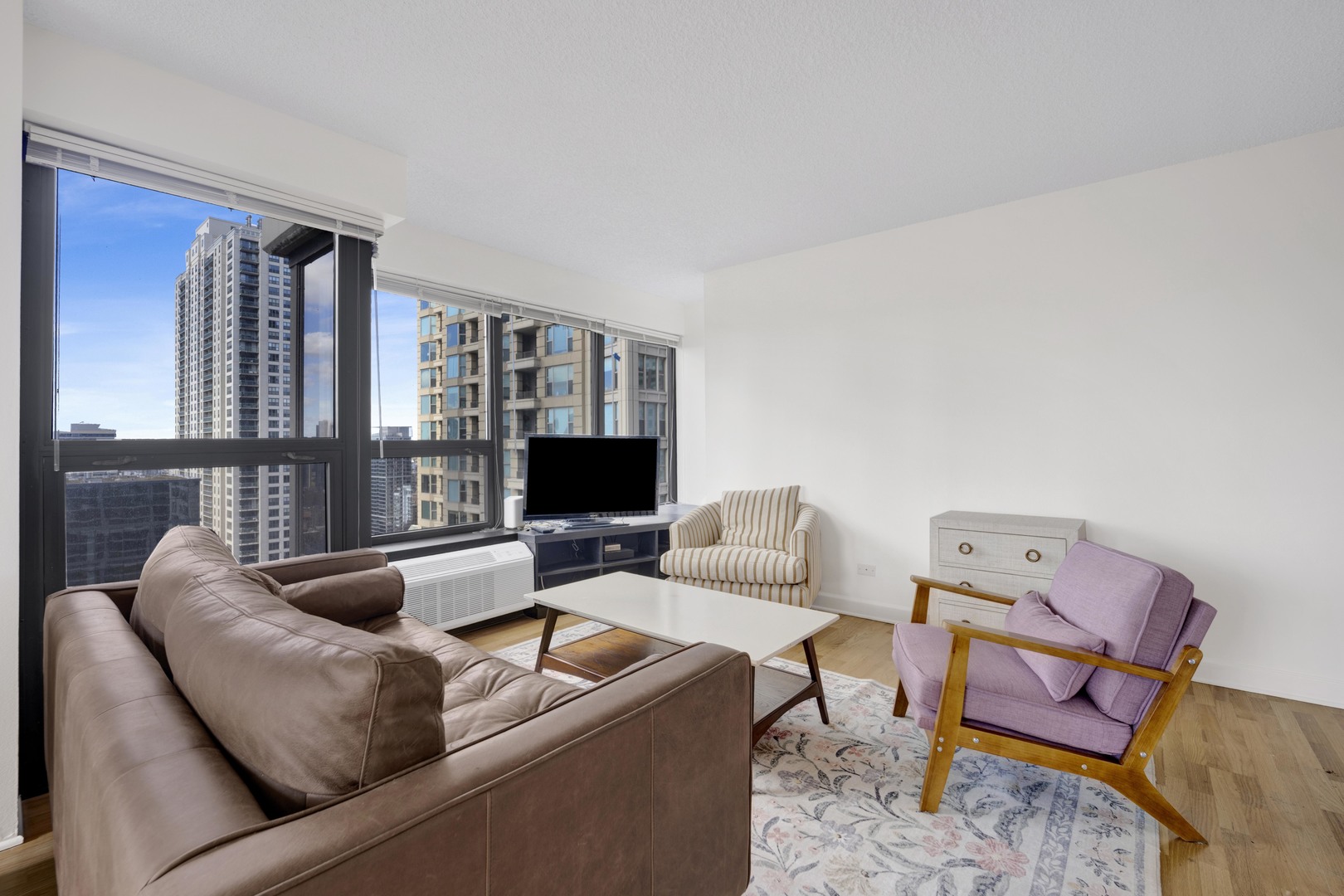 30 East Huron Street, Unit 3204 Chicago, IL 60611 - Photo 9 of 17 a living room with furniture and a flat screen tv