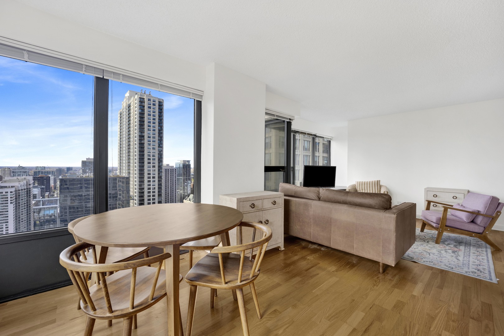 30 East Huron Street, Unit 3204 Chicago, IL 60611 - Photo 10 of 17 a living room with furniture and a wooden floor