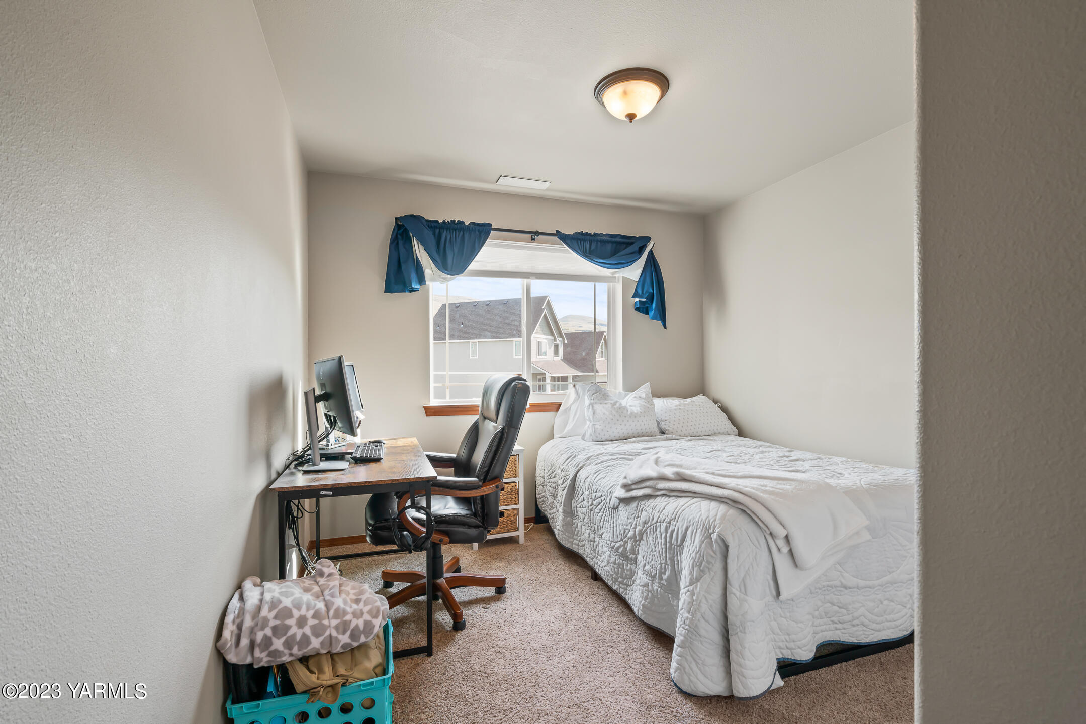 4702 Goat Rocks Court Yakima, WA 98901 - Photo 18 of 36 a bedroom with a bed a desk and chair