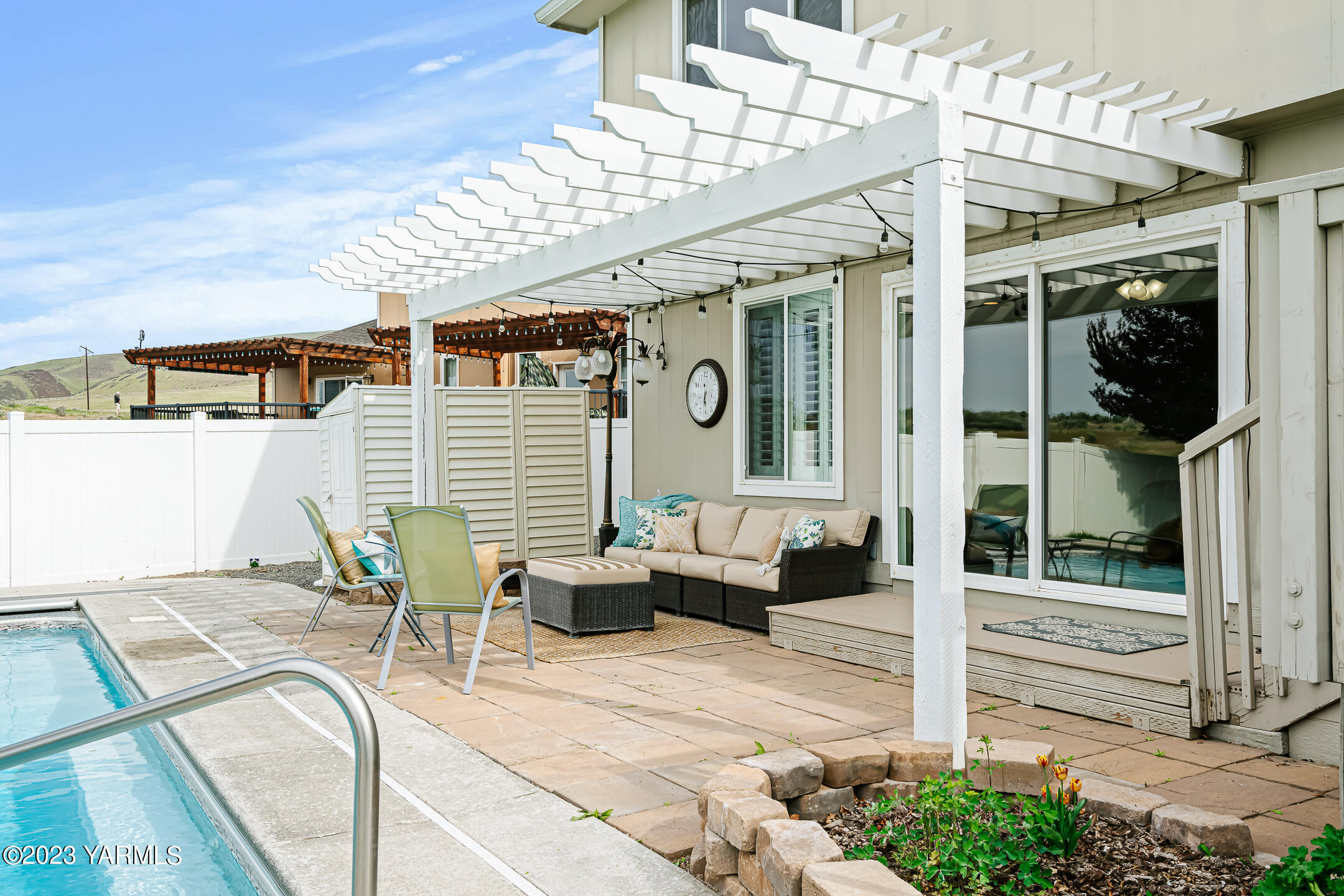 4702 Goat Rocks Court Yakima, WA 98901 - Photo 29 of 36 a view of a patio with couches table and chairs with potted plants