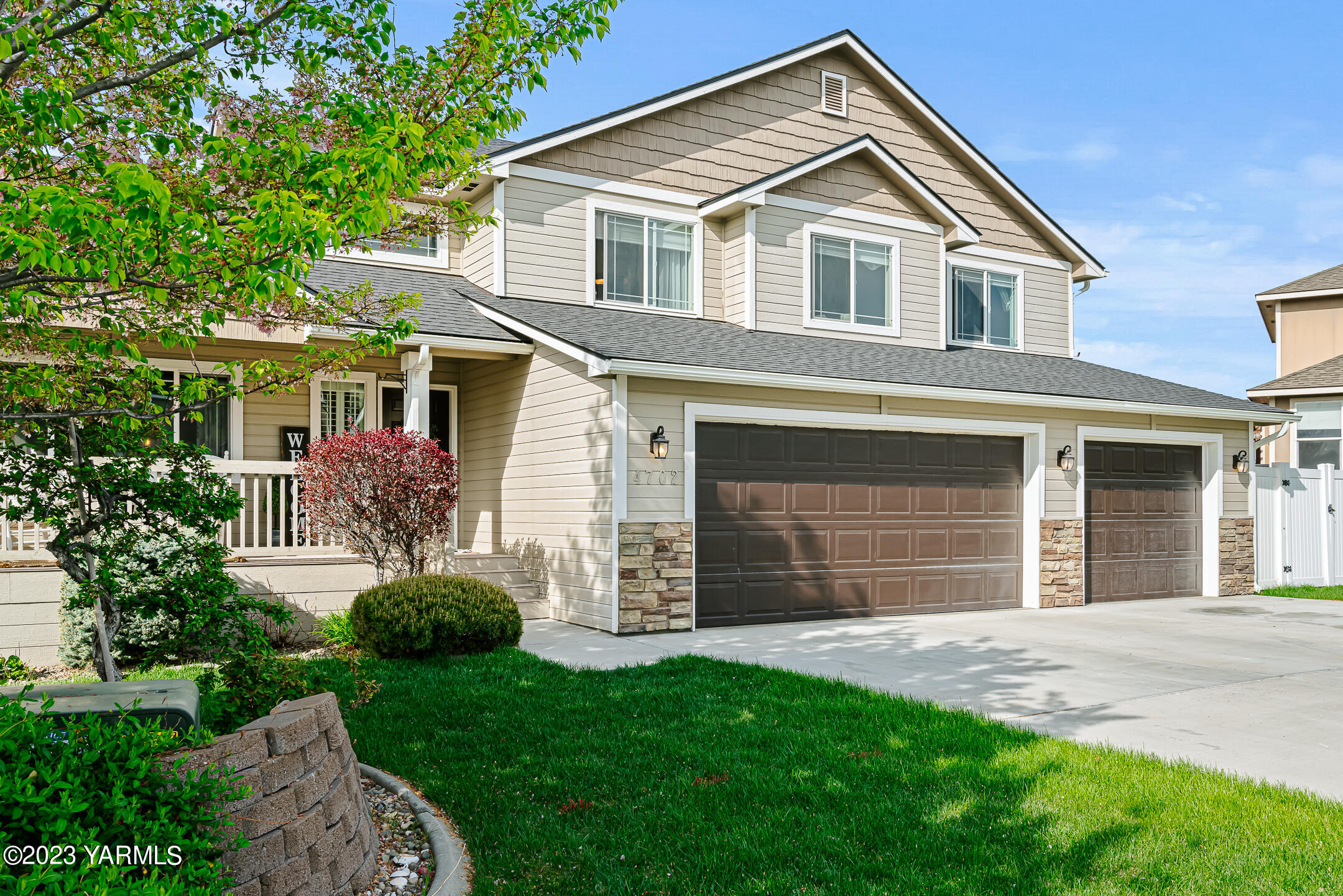 4702 Goat Rocks Court Yakima, WA 98901 - Photo 34 of 36 a front view of a house with a garden and plants