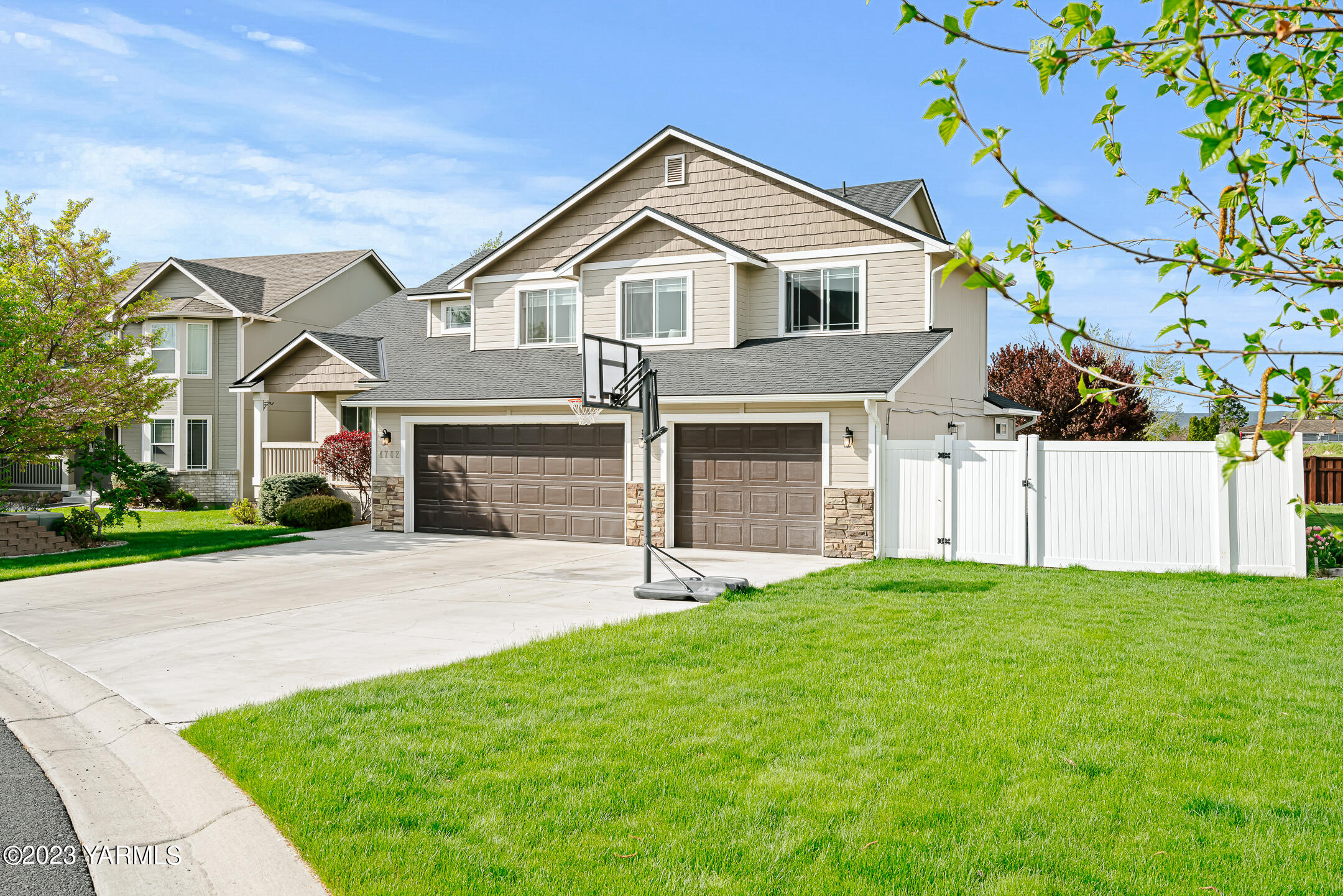 4702 Goat Rocks Court Yakima, WA 98901 - Photo 35 of 36 a front view of a house with a yard and garage