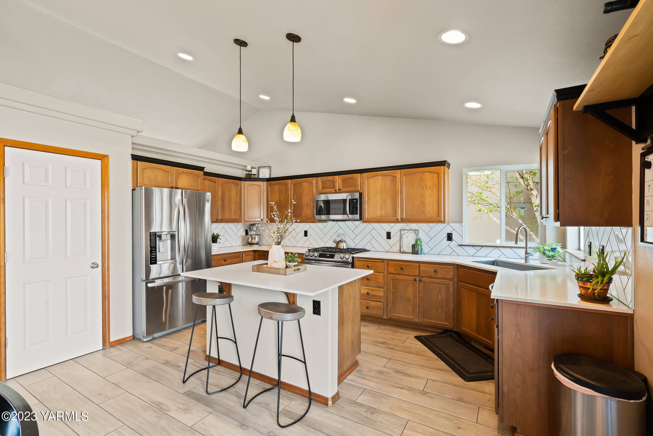 4702 Goat Rocks Court Yakima, WA 98901 - Photo 9 of 36 a kitchen with stainless steel appliances granite countertop a sink a stove a refrigerator cabinets and dining table