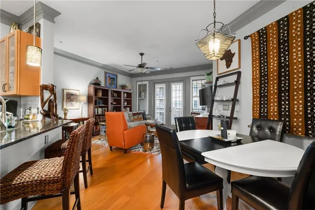 a kitchen with stainless steel appliances a table and chairs in it