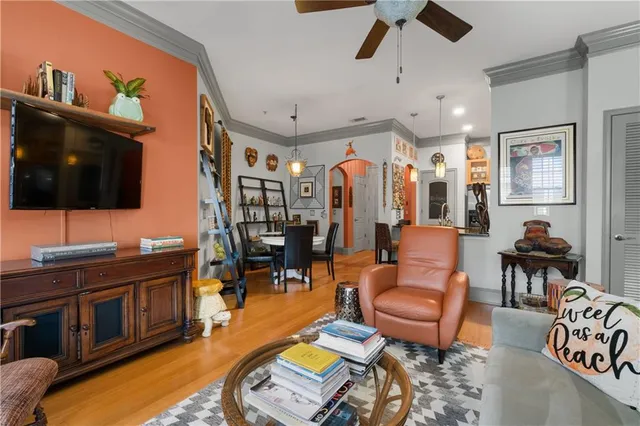 a living room with furniture ceiling fan and a rug