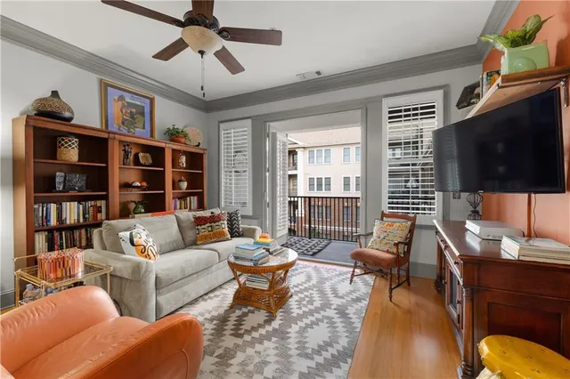 a bedroom with a bed and a flat tv screen on the dresser