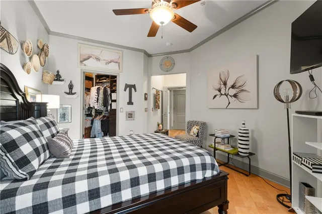 a view of walk in closet with clothes