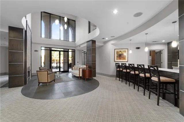 a large kitchen with a sink and dishwasher a oven with wooden cabinets