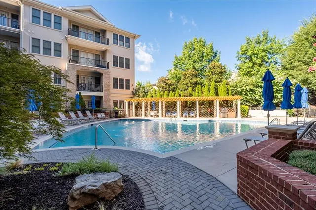 a view of a swimming pool with outdoor seating