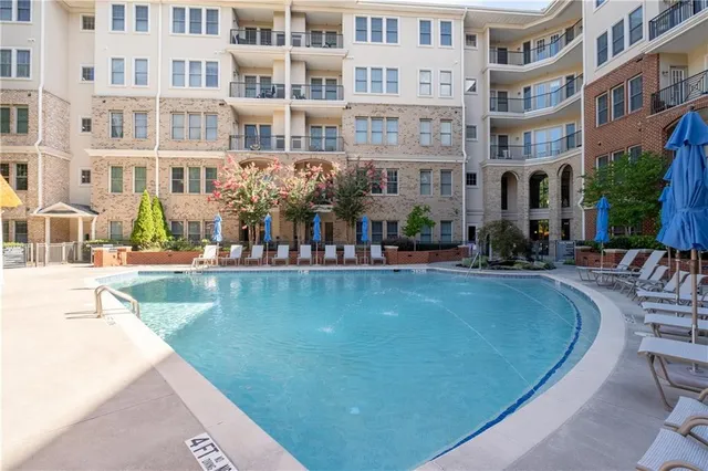 a view of pool with outdoor seating