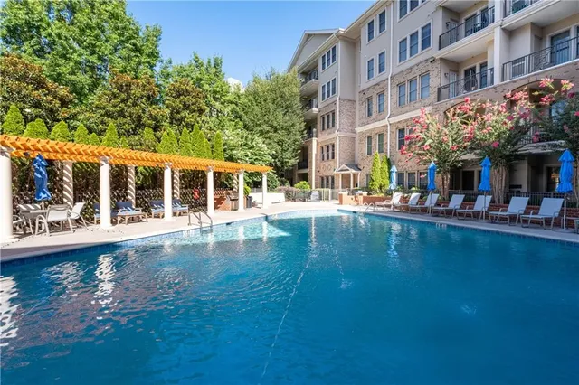 a room with stainless steel appliances kitchen island granite countertop furniture and a fireplace