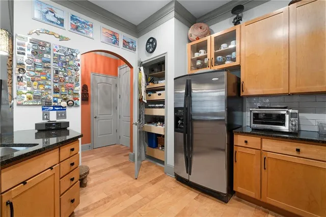 a kitchen with stainless steel appliances a sink stove and cabinets