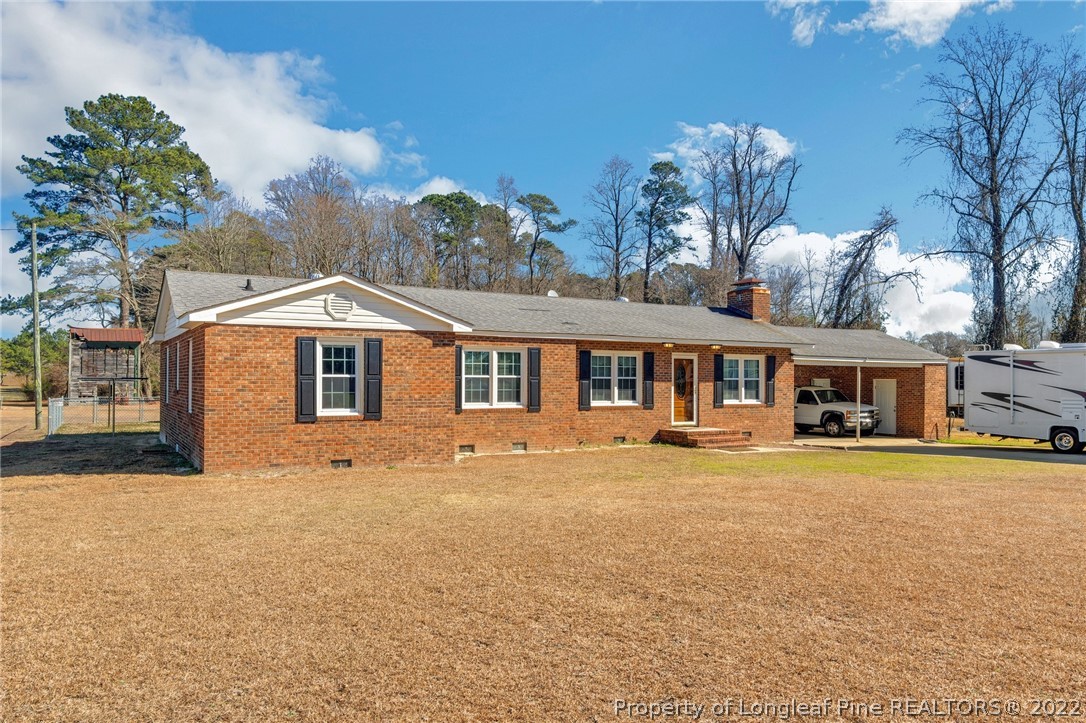 5457 Sambo Jackson Road Godwin, NC 28344 - Photo 1 of 33 a front view of a house with a yard and garage