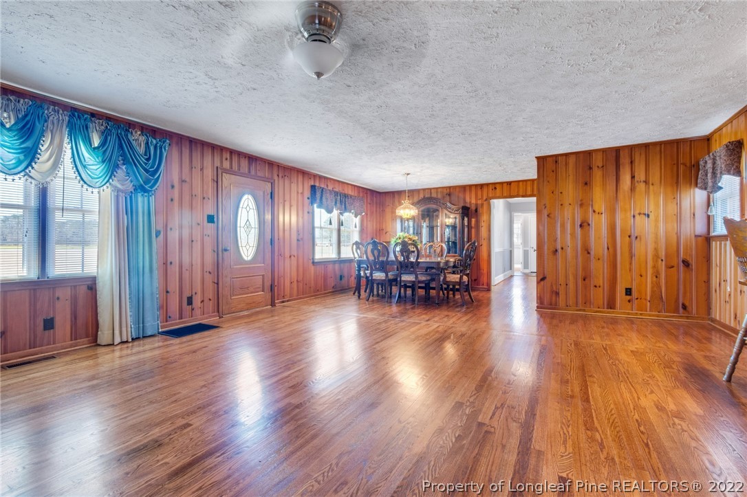 5457 Sambo Jackson Road Godwin, NC 28344 - Photo 11 of 33 a view of an empty room with wooden floor and windows