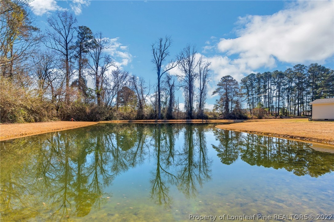 5457 Sambo Jackson Road Godwin, NC 28344 - Photo 2 of 33 a view of a swimming pool and trees in the background