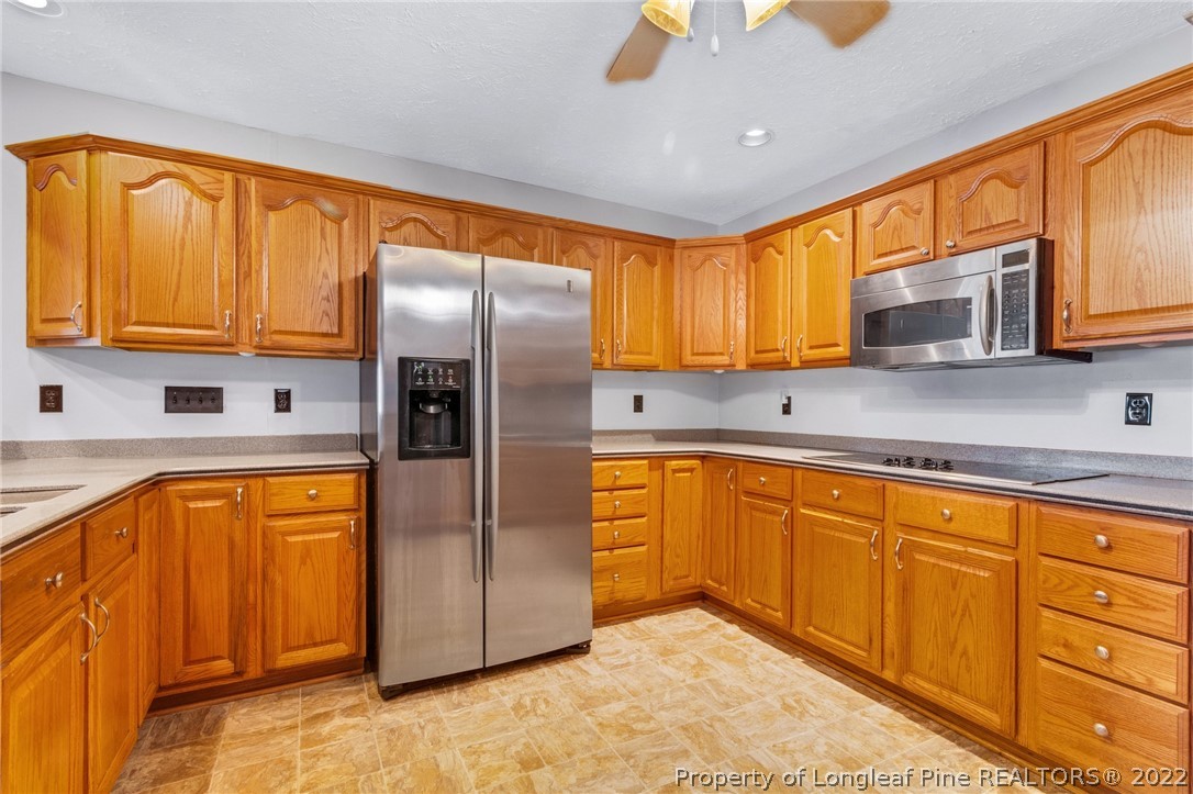 5457 Sambo Jackson Road Godwin, NC 28344 - Photo 6 of 33 a kitchen with stainless steel appliances granite countertop a refrigerator a sink dishwasher stove top oven and cabinets