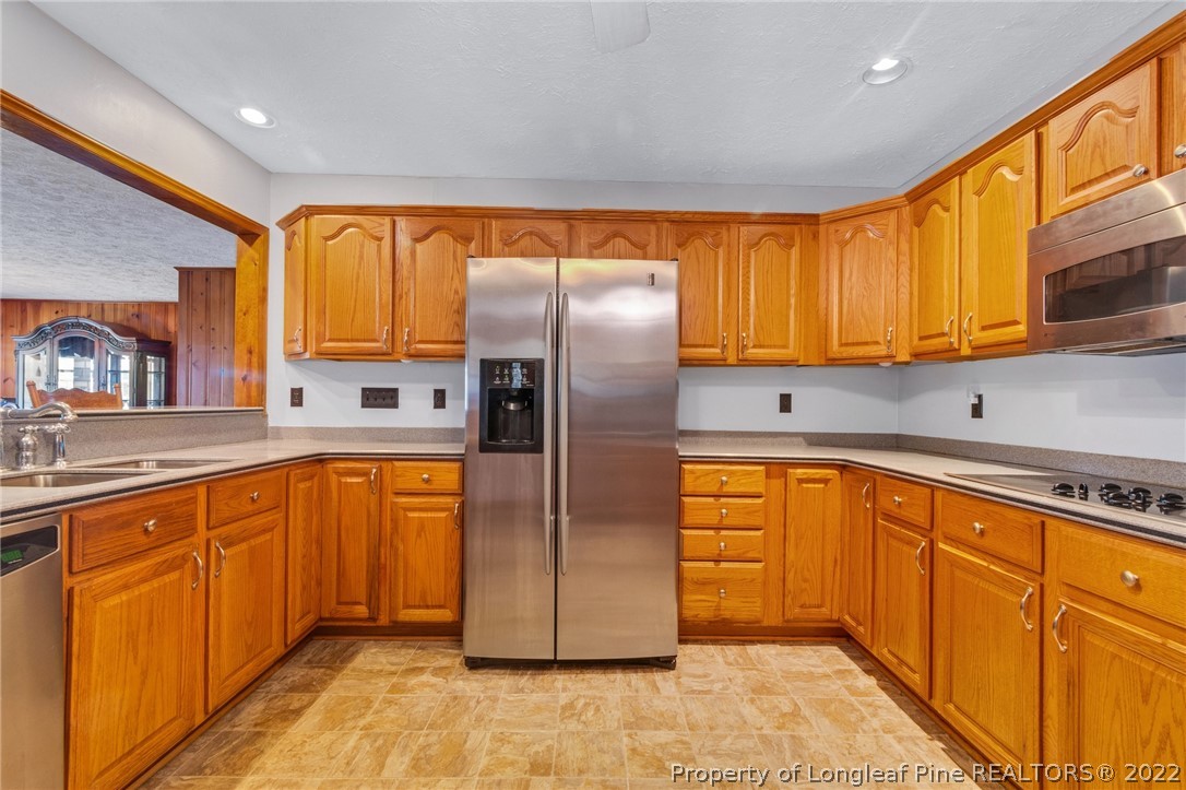 5457 Sambo Jackson Road Godwin, NC 28344 - Photo 7 of 33 a kitchen with stainless steel appliances granite countertop a refrigerator a sink dishwasher stove and oven