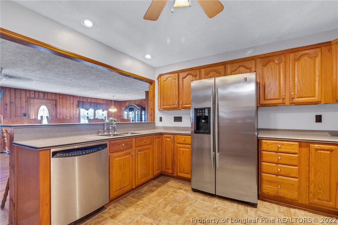 5457 Sambo Jackson Road Godwin, NC 28344 - Photo 8 of 33 a kitchen with stainless steel appliances granite countertop a refrigerator and a sink