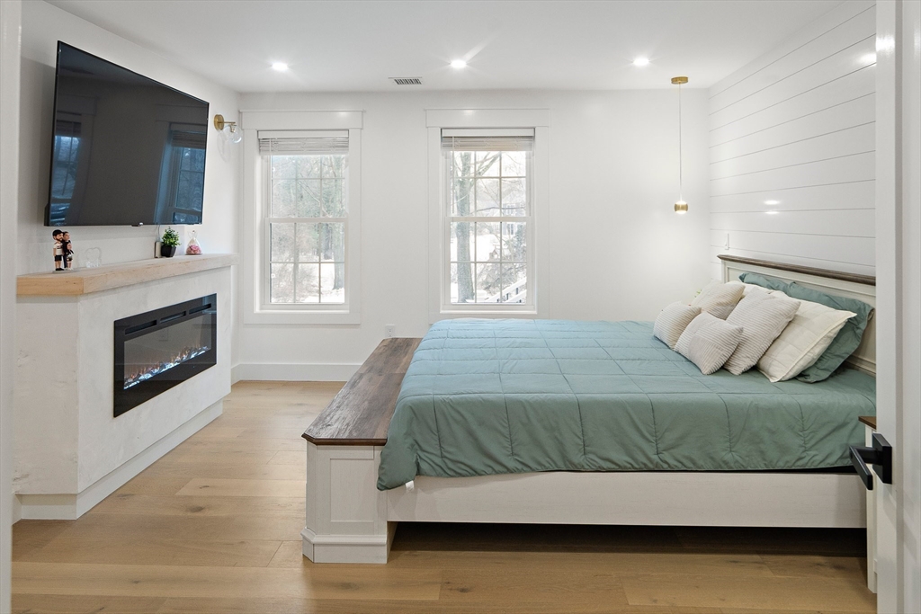 355 Maynard Road Sudbury, MA 01776 - Photo 11 of 18 a bedroom with a large bed and a flat screen tv