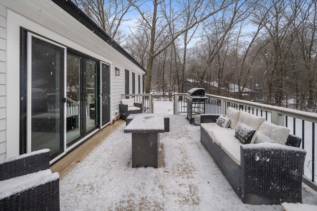 355 Maynard Road Sudbury, MA 01776 - Photo 17 of 18 a view of a patio with couches table and chairs and wooden floor