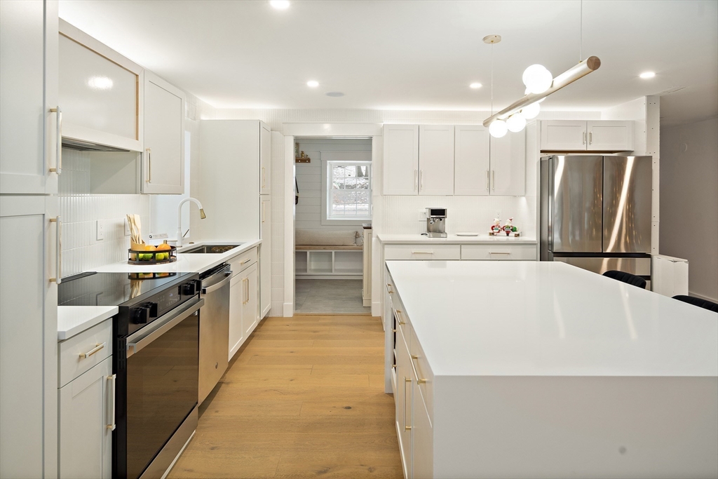 355 Maynard Road Sudbury, MA 01776 - Photo 4 of 18 a kitchen with stainless steel appliances a refrigerator sink and wooden cabinets