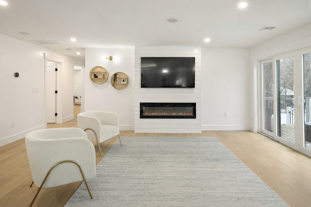 355 Maynard Road Sudbury, MA 01776 - Photo 7 of 18 a living room with furniture and a flat screen tv