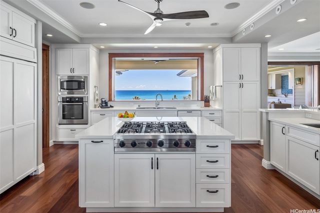 a kitchen with stainless steel appliances a stove a sink and a microwave
