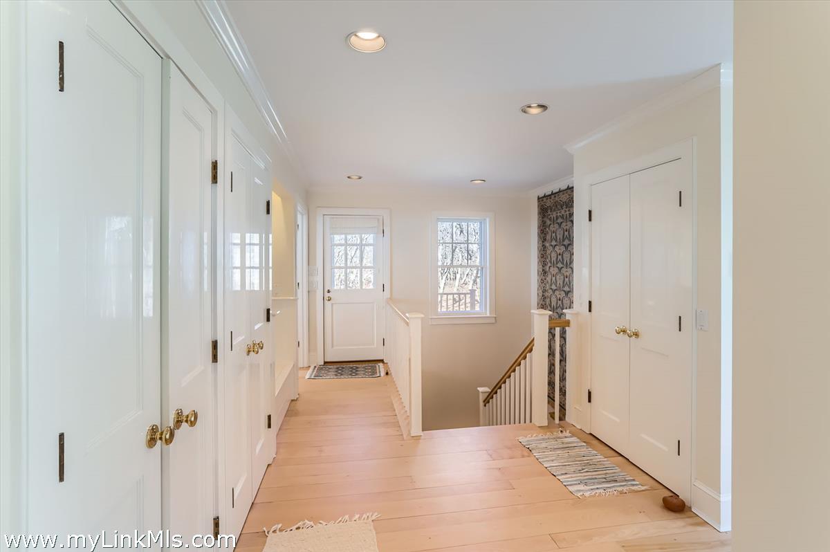 78 Hammett Road Chilmark, MA 02535 - Photo 28 of 53 a view of a hallway with wooden floor and cabinet