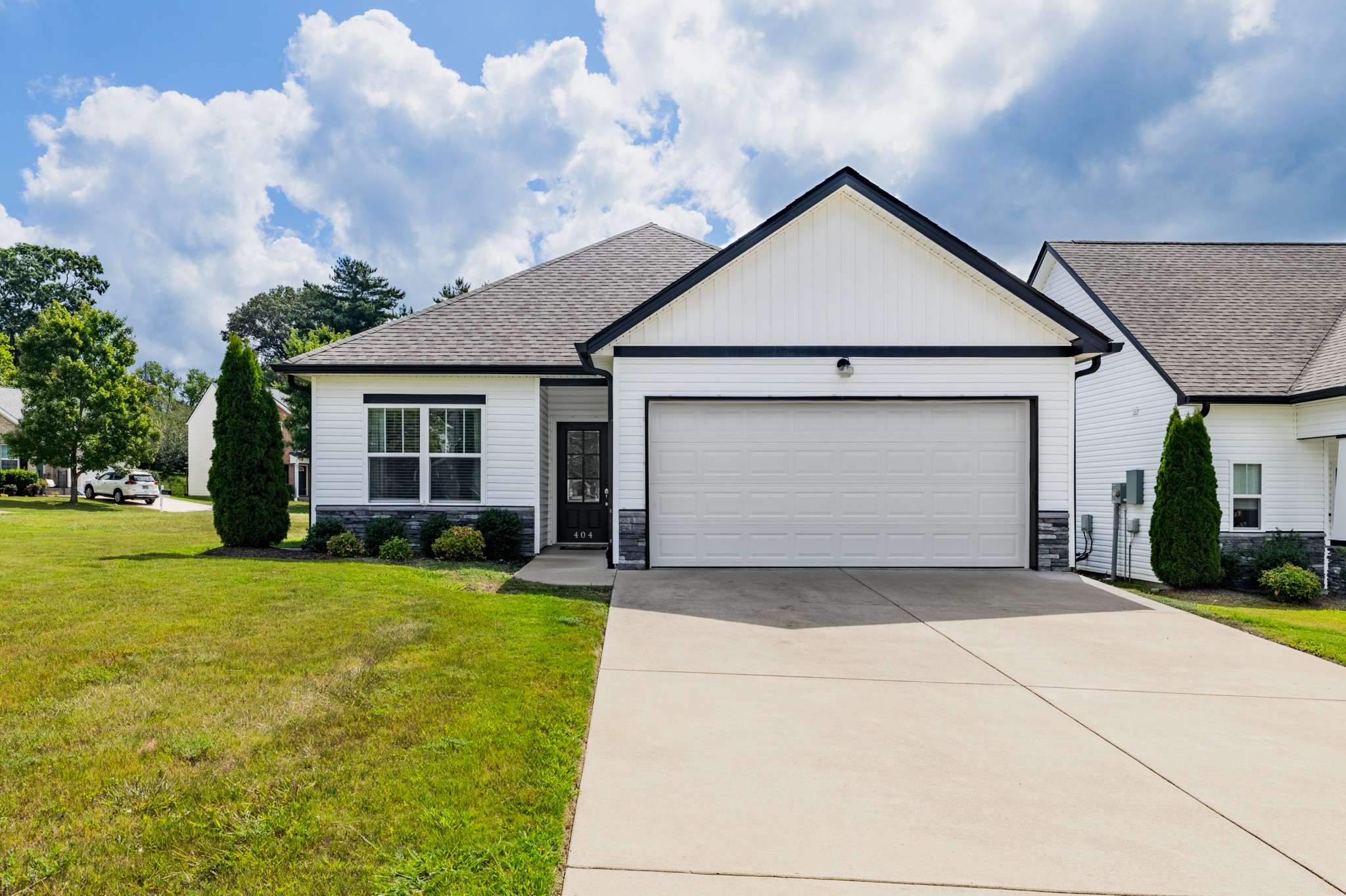 a front view of a house with yard and garage