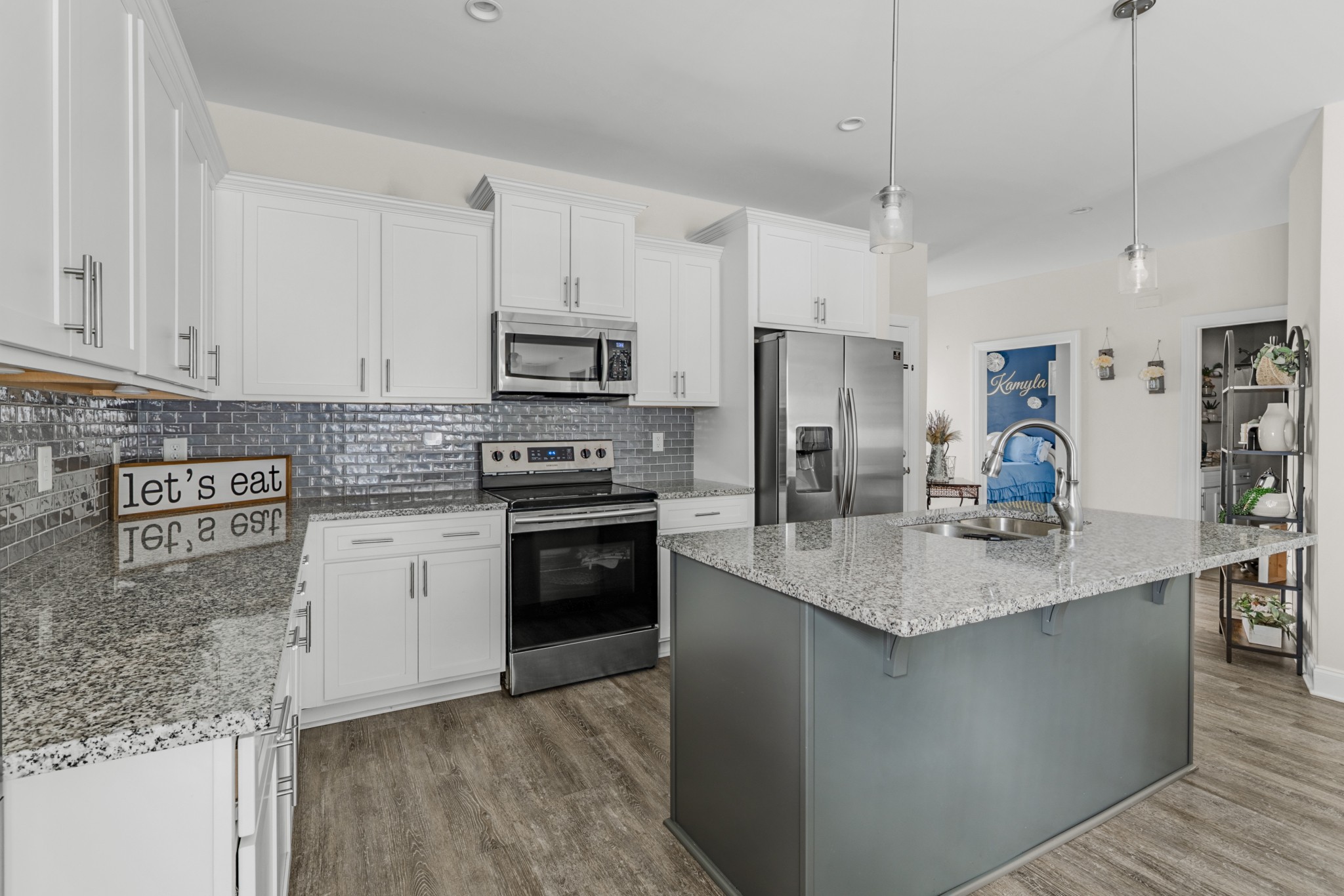404 Golf Club Lane Springfield, TN 37172 - Photo 4 of 38 a kitchen with stainless steel appliances granite countertop a sink stove refrigerator and cabinets