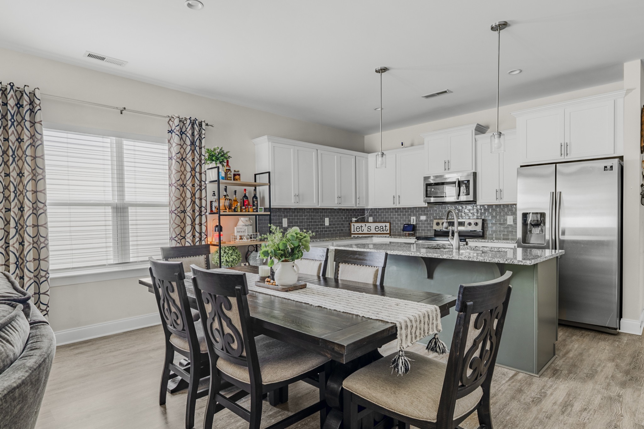 404 Golf Club Lane Springfield, TN 37172 - Photo 6 of 38 a kitchen with stainless steel appliances granite countertop a dining table chairs refrigerator and cabinets