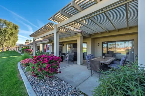 a view of a house with backyard sitting area and garden