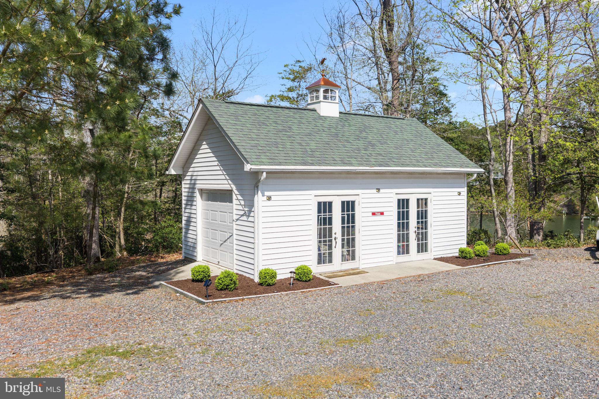 249 Spring Hill Road Lancaster, VA 22503 - Photo 54 of 65 a view of a house with a yard and garage