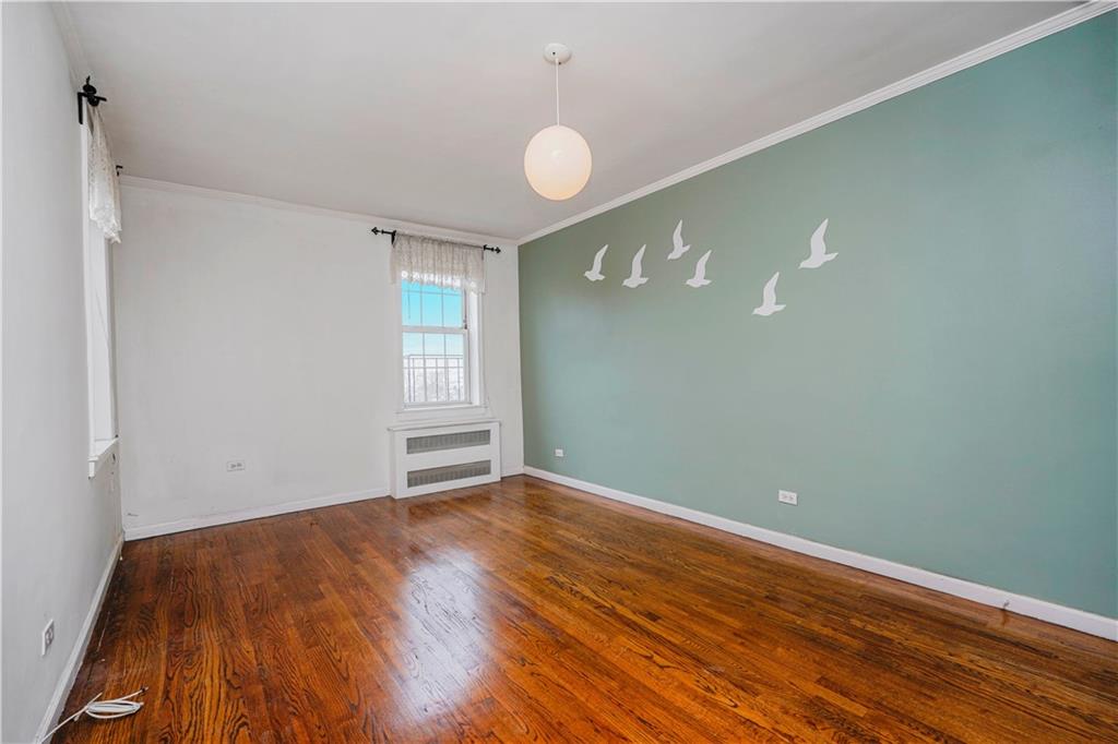 6665 Colonial Road, Unit 6E Brooklyn, NY 11220 - Photo 15 of 22 a view of empty room with wooden floor and fan