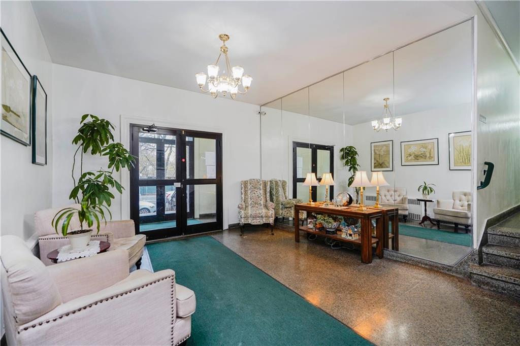 6665 Colonial Road, Unit 6E Brooklyn, NY 11220 - Photo 2 of 22 a living room with furniture and a chandelier