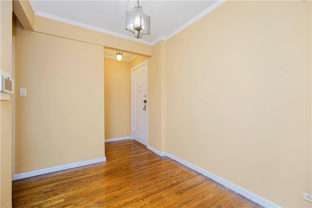 6665 Colonial Road, Unit 6E Brooklyn, NY 11220 - Photo 4 of 22 a view of an empty room with wooden floor