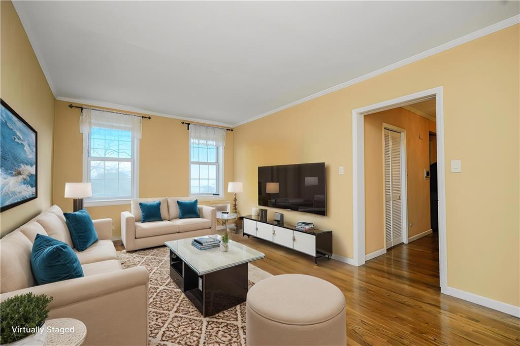 6665 Colonial Road, Unit 6E Brooklyn, NY 11220 - Photo 6 of 22 a living room with furniture and a flat screen tv