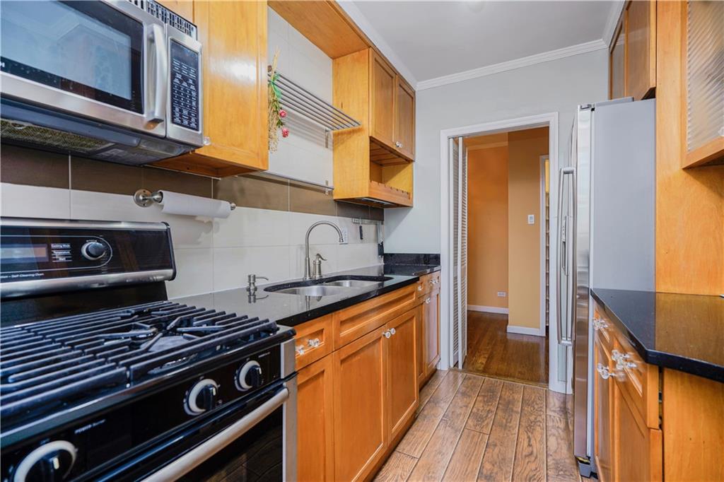 6665 Colonial Road, Unit 6E Brooklyn, NY 11220 - Photo 10 of 22 a kitchen with stainless steel appliances granite countertop a stove and a sink
