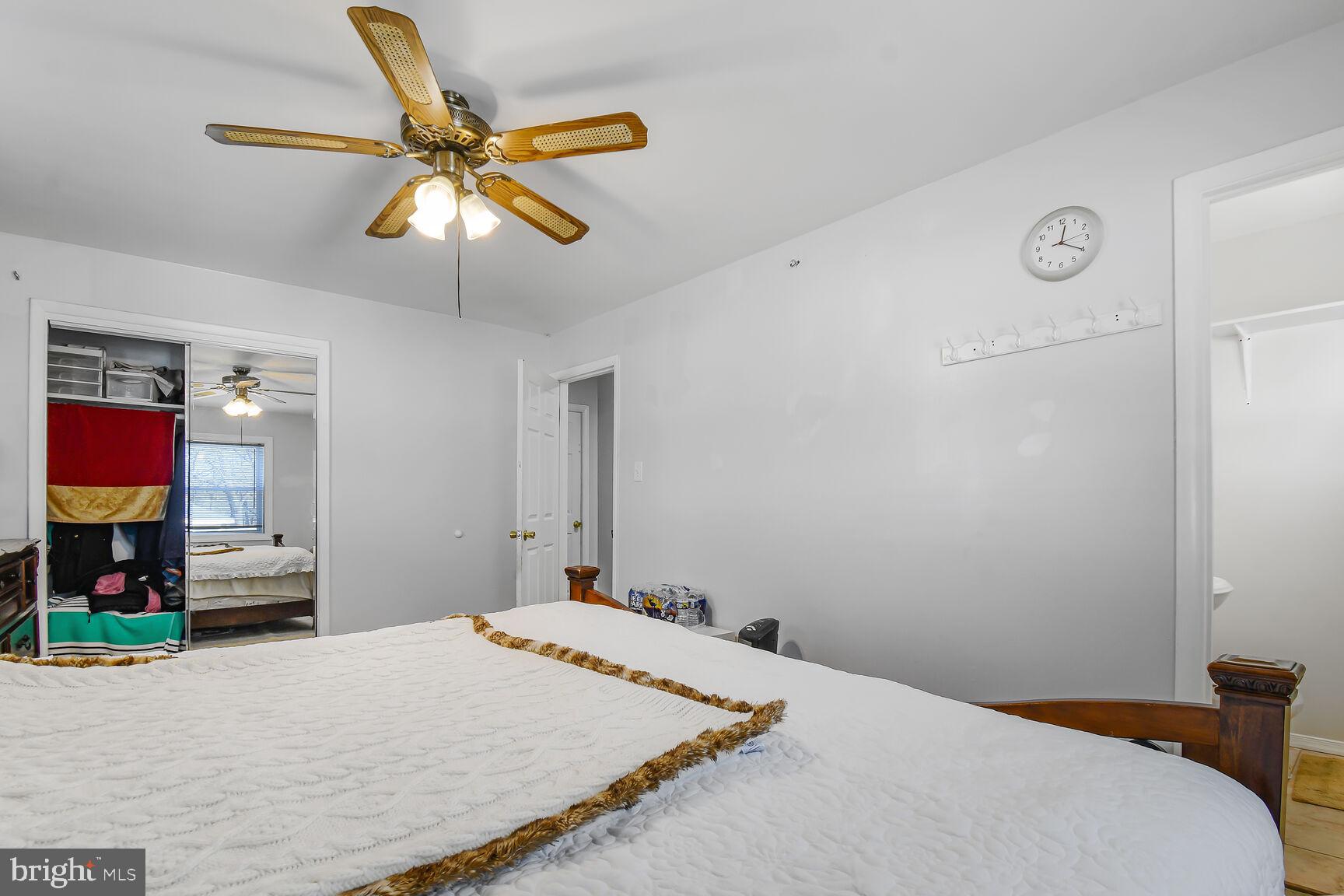 9604 Lanham Severn Road Lanham, MD 20706 - Photo 21 of 30 a bedroom with a bed and a chandelier
