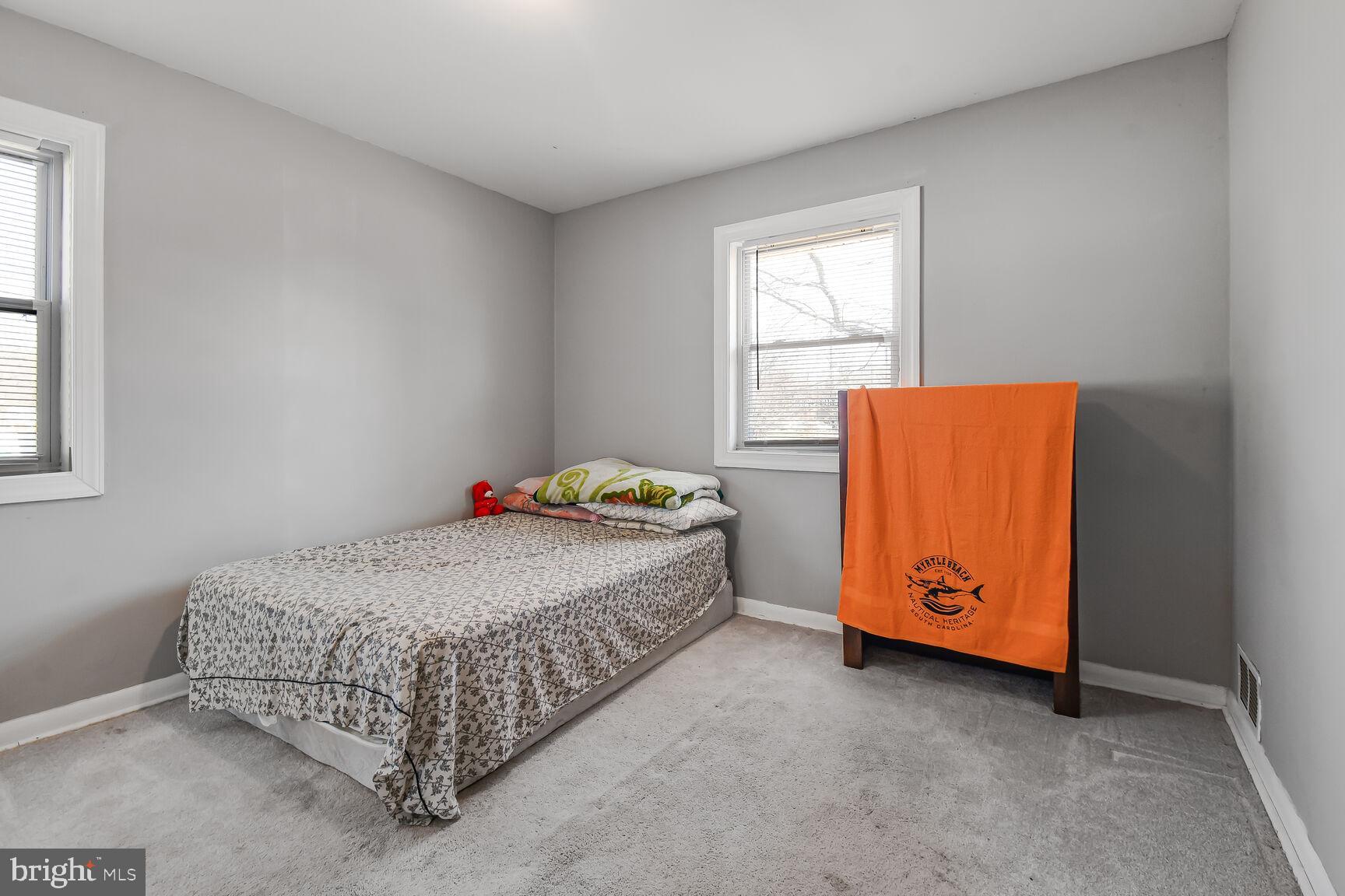 9604 Lanham Severn Road Lanham, MD 20706 - Photo 22 of 30 a bedroom with a bed and window