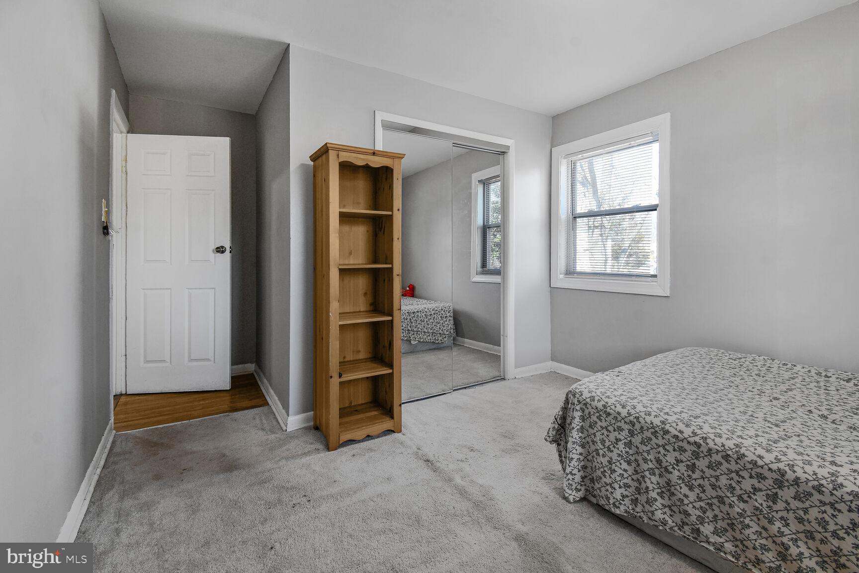 9604 Lanham Severn Road Lanham, MD 20706 - Photo 23 of 30 a spacious bedroom with a bed and a window