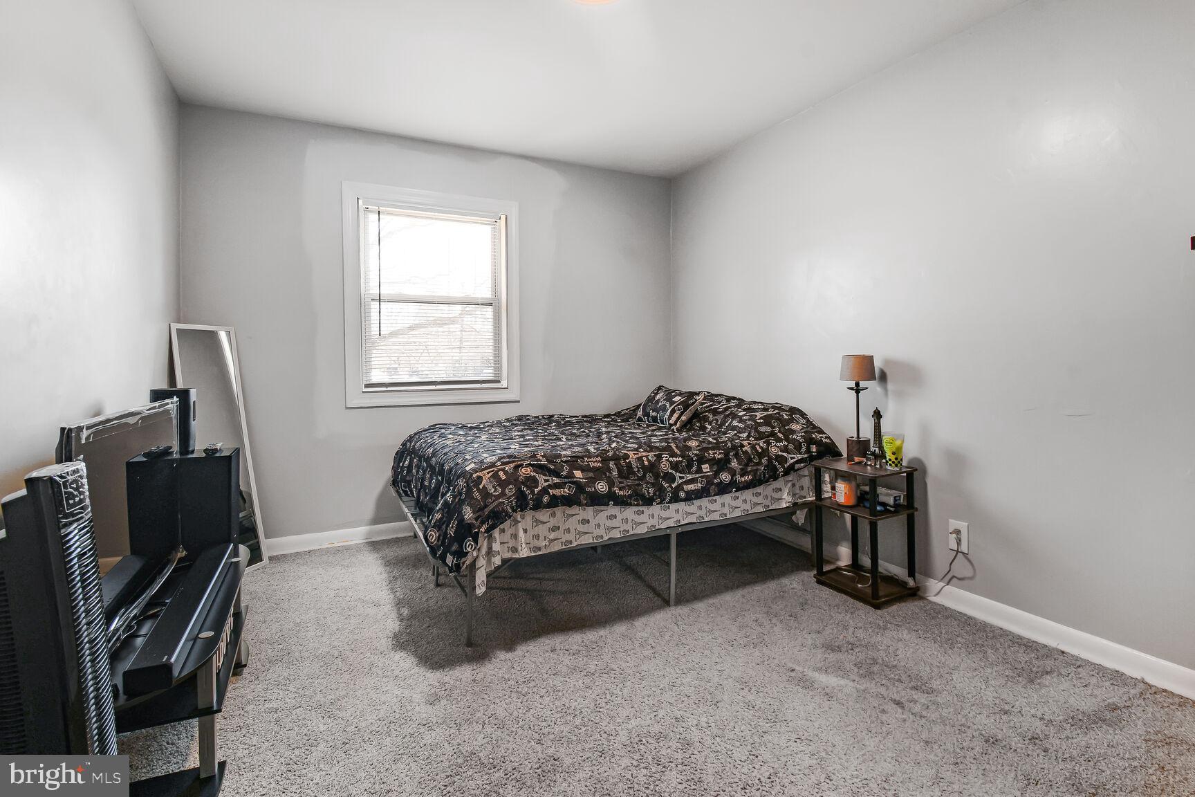 9604 Lanham Severn Road Lanham, MD 20706 - Photo 24 of 30 a bedroom with a bed and a flat tv screen on the dresser