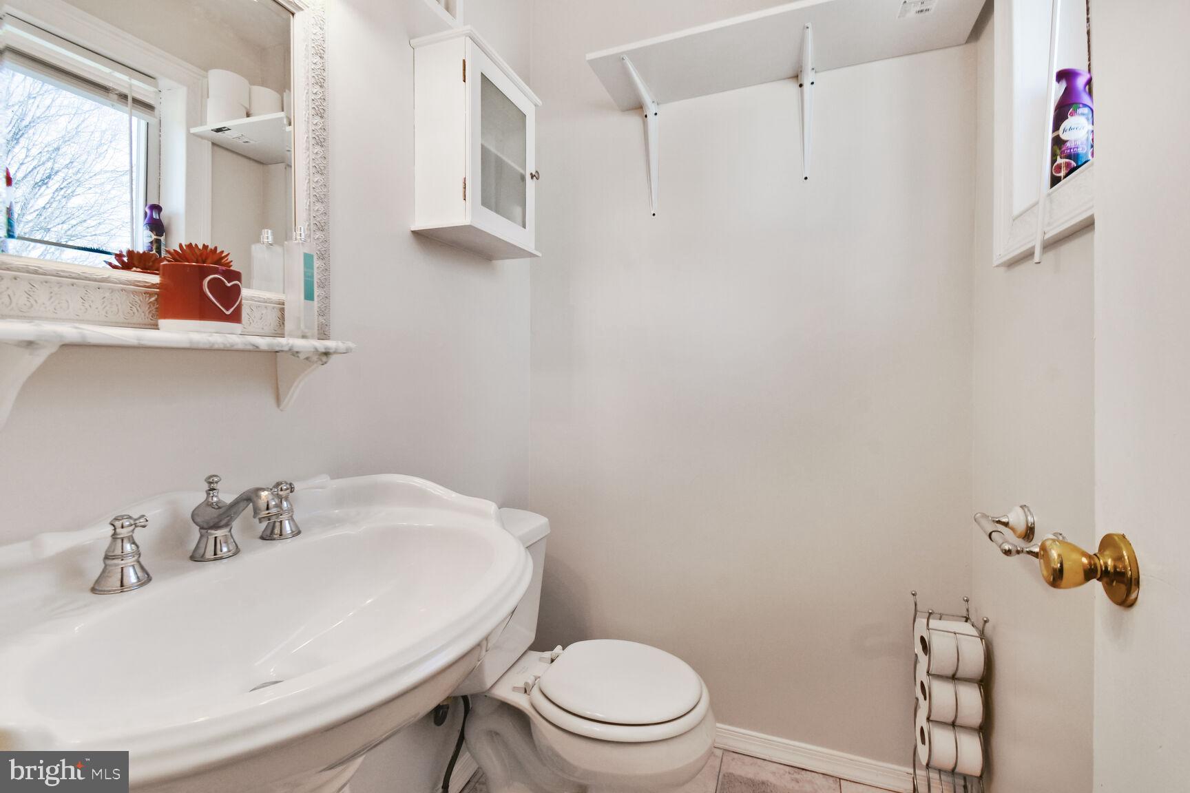 9604 Lanham Severn Road Lanham, MD 20706 - Photo 28 of 30 a bathroom with a sink toilet and a mirror