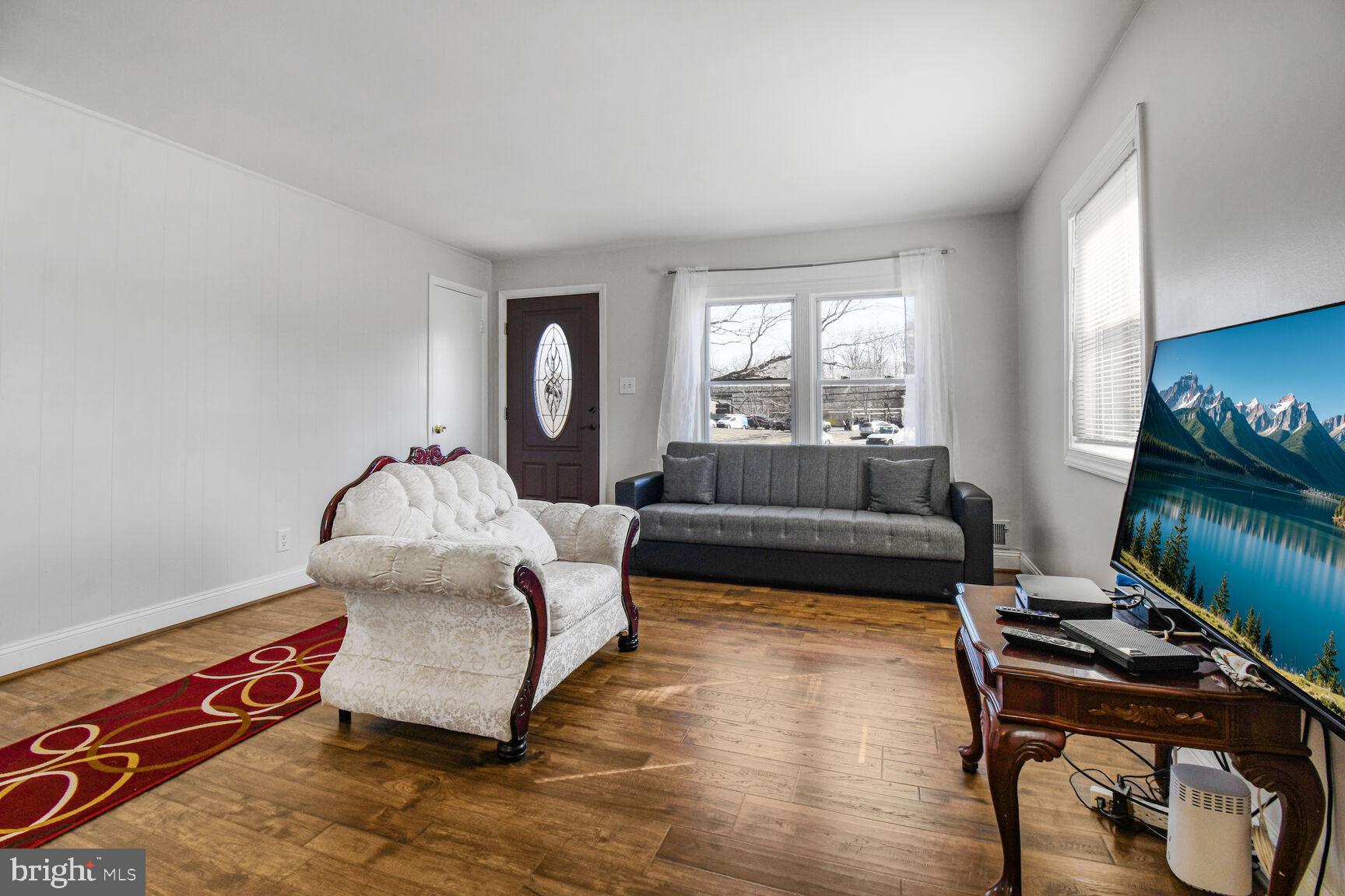 9604 Lanham Severn Road Lanham, MD 20706 - Photo 3 of 30 a living room with furniture and a flat screen tv