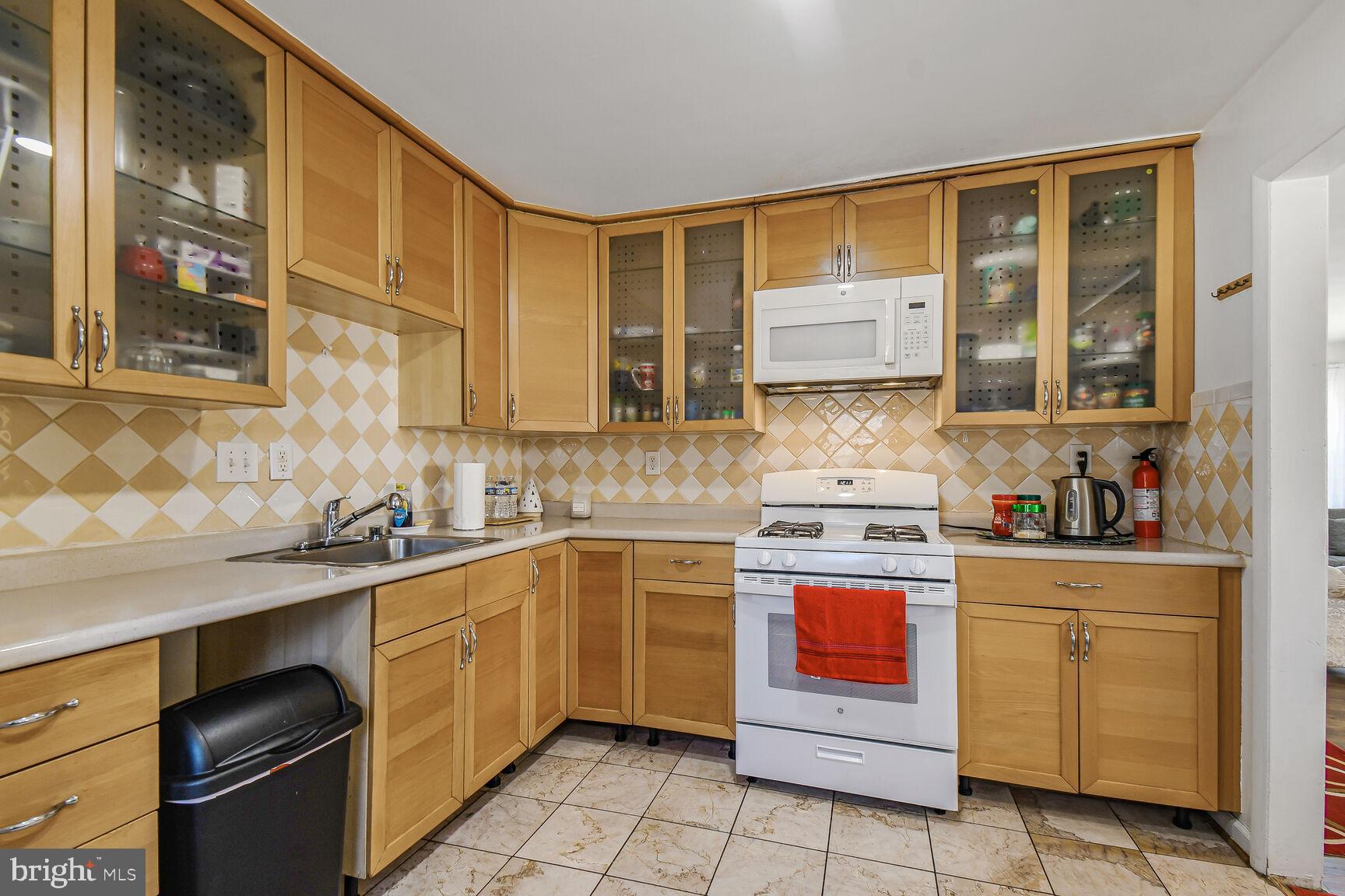 9604 Lanham Severn Road Lanham, MD 20706 - Photo 7 of 30 a kitchen with stainless steel appliances granite countertop a stove sink and cabinets