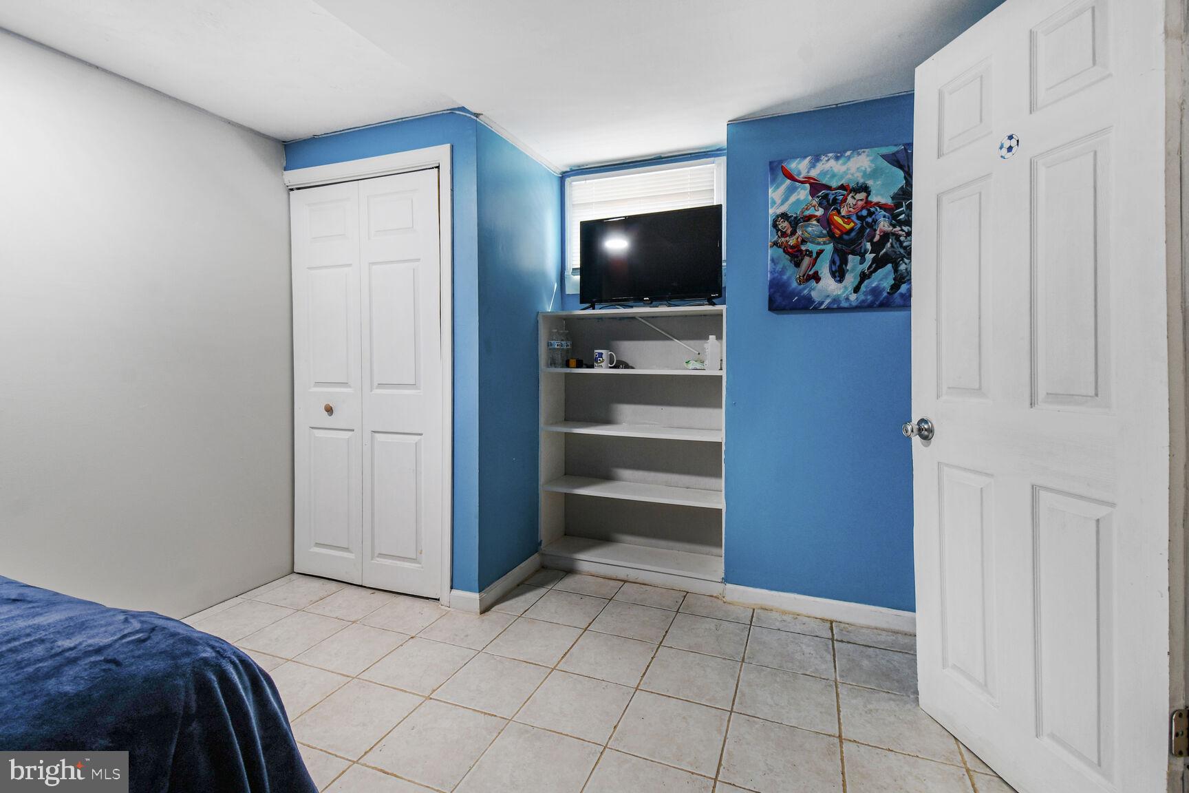 9604 Lanham Severn Road Lanham, MD 20706 - Photo 10 of 30 a bedroom with a bed and a television in it