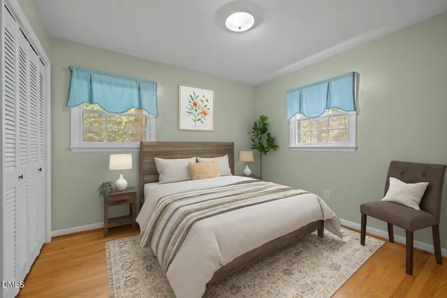 a bedroom with a bed and a chair