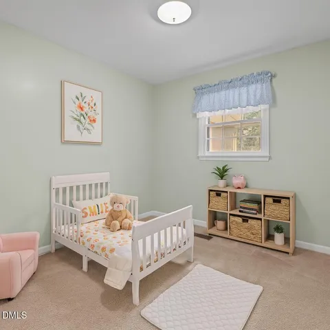 a bedroom with furniture and a baby crib