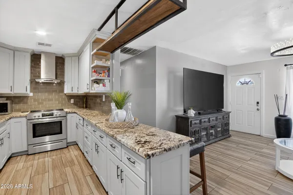 a kitchen with sink stove and cabinets