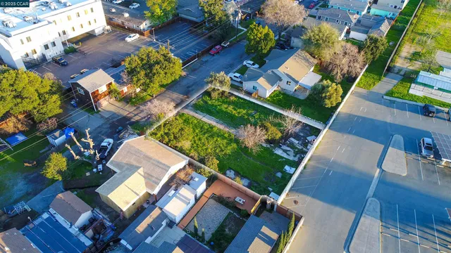an aerial view of a house with garden space and street view